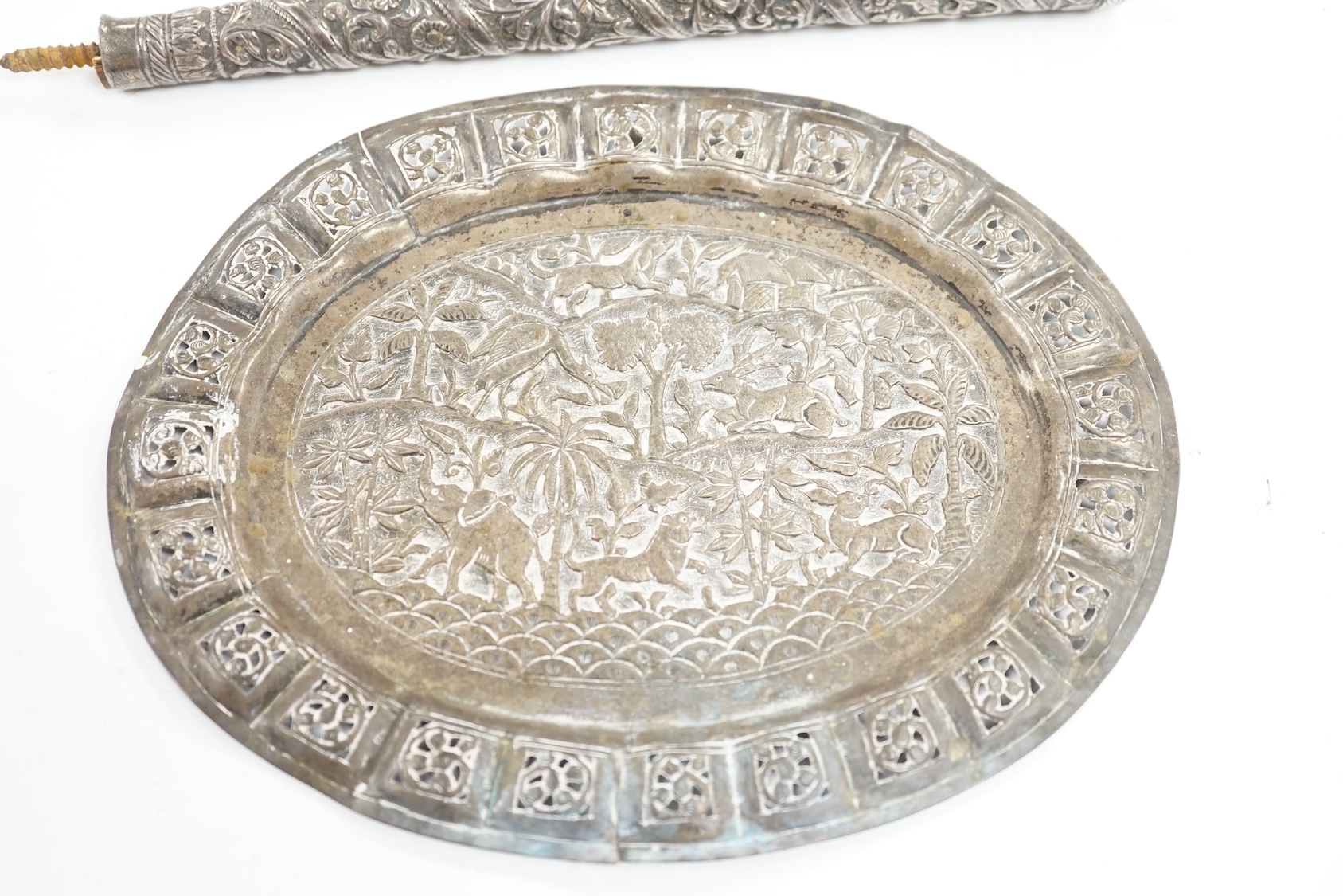 An Indian pierced white metal oval plaque and a white metal cane handle. Condition - poor to fair